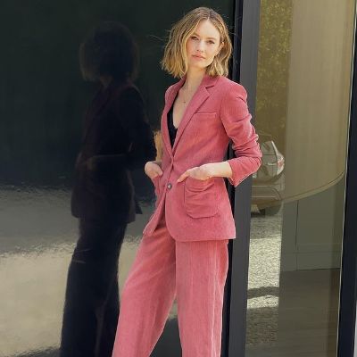 Catlin is wearing a pink jacket and pink pant.